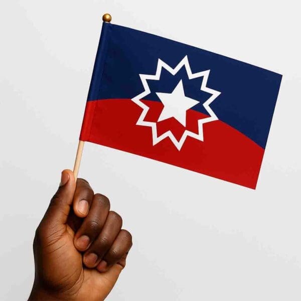 Hand holding a vibrant B1ClothingCo Juneteenth hand flag, symbol of freedom and heritage.