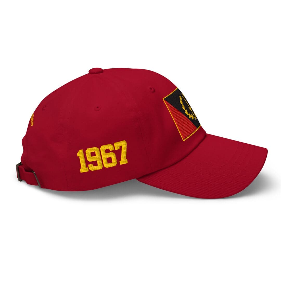 Right side view of the cranberry Black American Heritage Flag Dad Hat, highlighting the gold '1967' embroidery.